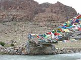 Tibet Kailash 08 Kora 11 Bridge Over Lha Chu Towards Chuku Gompa The Mount Kailash kora is 52km in length, crosses the 5630m D�lma La and normally takes three days. There were no yaks available at Darchen, so our cook Paldi and porter Pemba Rinji agreed to be yaks and carry our gear. They were also paid the yak rate, about 80 yuan a day. After leaving Tarboche, we walked for just 30 minutes and reached a small bridge (4710m) across the Lha Chu (Divine River) with the trail to Chuku Gompa beyond.